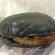 Illustration for article titled Burger King's all-black burger looks absolutely disgusting in real life